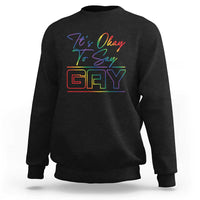 Black crewneck sweatshirt with colorful “It’s Okay To Say Gay” graphic