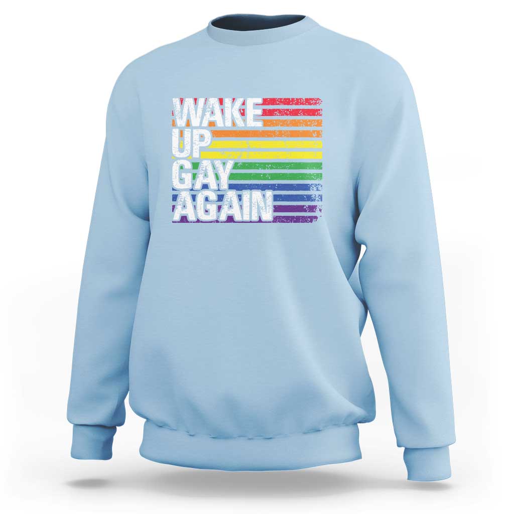 Light blue crewneck sweatshirt with rainbow "Wake Up Gay Again" graphic on front