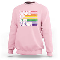 Light pink crewneck sweatshirt with rainbow "Wake Up Gay Again" graphic on front