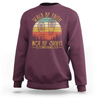 Maroon crewneck sweatshirt with “Walk by Faith Not by Sight” graphic, 2 Cor 5:7.