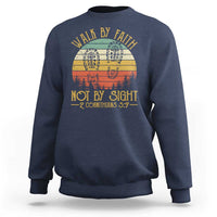 Navy crewneck sweatshirt with “Walk by Faith Not by Sight” graphic, 2 Cor 5:7.