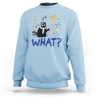 Light blue sweatshirt with cat graphic and “WHAT?” text, long sleeves, crew neck