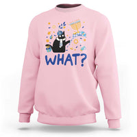 Light pink sweatshirt with cat graphic and “WHAT?” text, long sleeves, crew neck