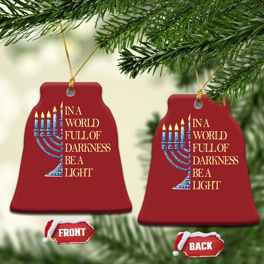 Two red bell-shaped ornaments with menorah and “In a world full of darkness, be a light” text