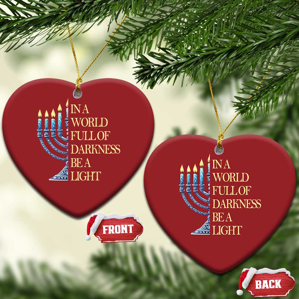 Two red heart-shaped ornaments with menorah graphic and “In a world full of darkness, be a light”