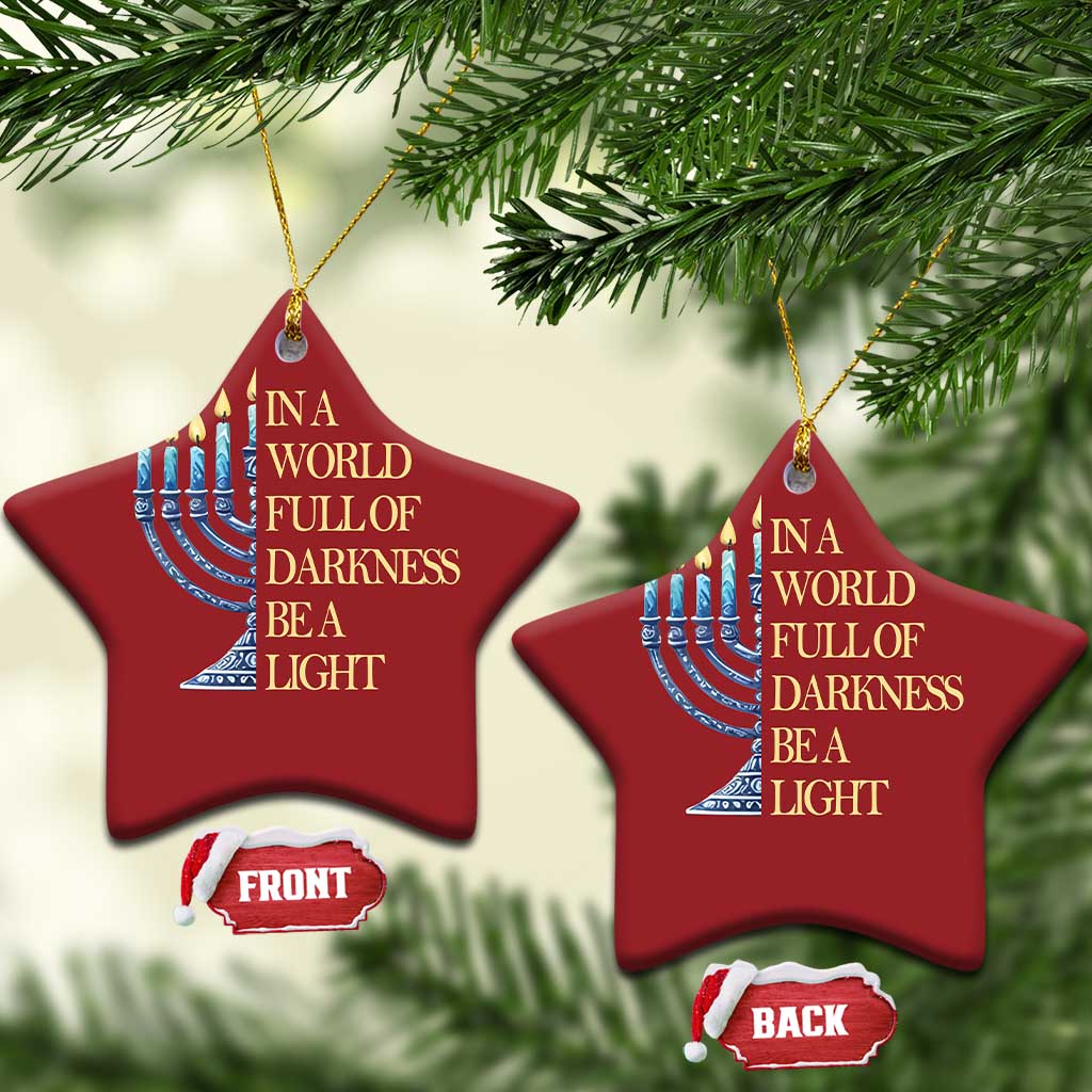 Two red star-shaped ornaments with menorah illustration and “In a world full of darkness, be a light”