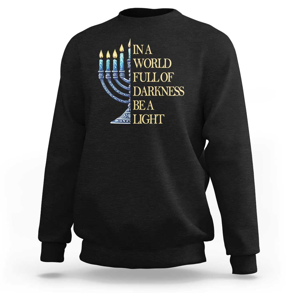 Black Hanukkah sweatshirt with blue menorah and 'Be a Light' text graphic