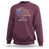 Maroon Hanukkah sweatshirt with blue menorah and 'Be a Light' text graphic