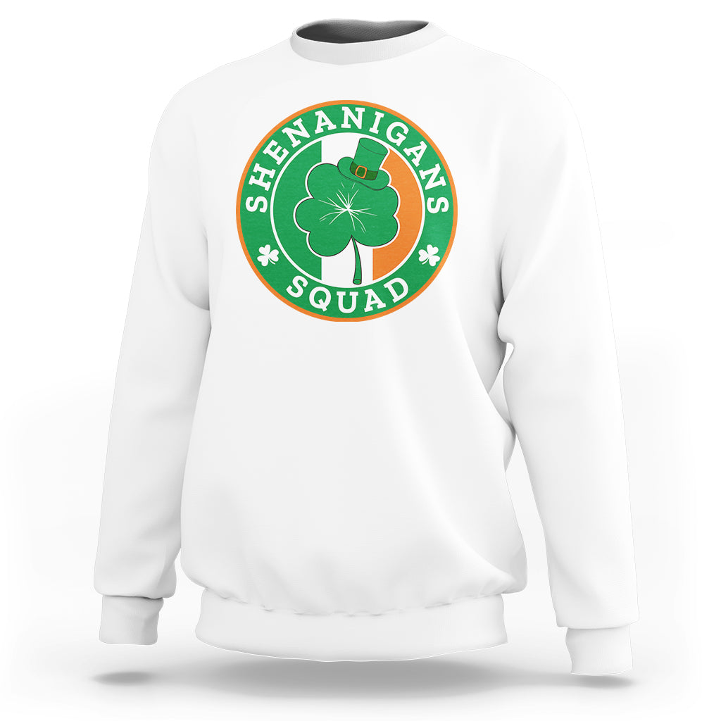 White sweatshirt with round “Shenanigans Squad” graphic featuring clover and hat