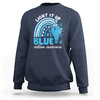 Navy autism awareness sweatshirt with 'Light It Up Blue' rainbow puzzle graphic