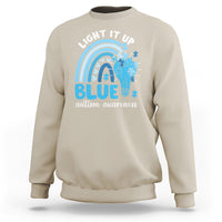 Sand autism awareness sweatshirt with 'Light It Up Blue' rainbow puzzle graphic