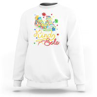 White autism awareness sweatshirt with colorful “Be a Kind Sole” puzzle shoe graphic