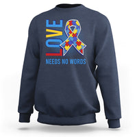 Navy autism awareness sweatshirt with puzzle heart graphic and “NEEDS NO WORDS” text