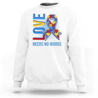 White autism awareness sweatshirt with puzzle heart graphic and “NEEDS NO WORDS” text