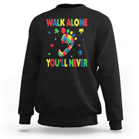 Black crewneck sweatshirt with autism puzzle graphic and colorful "WALK ALONE" and "YOU'LL NEVER"