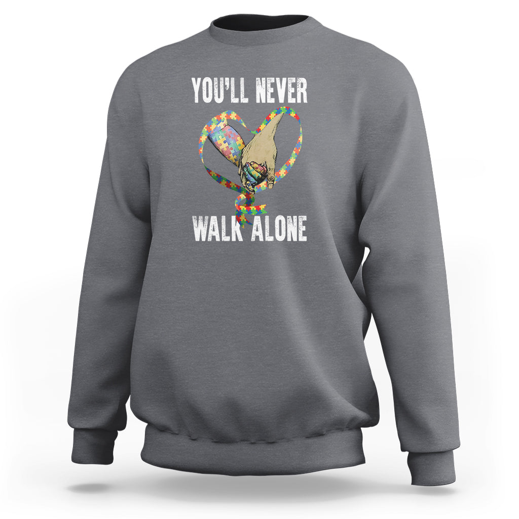 Charcoal crewneck sweatshirt with 'YOU'LL NEVER WALK ALONE' cat-and-heart graphic on back.