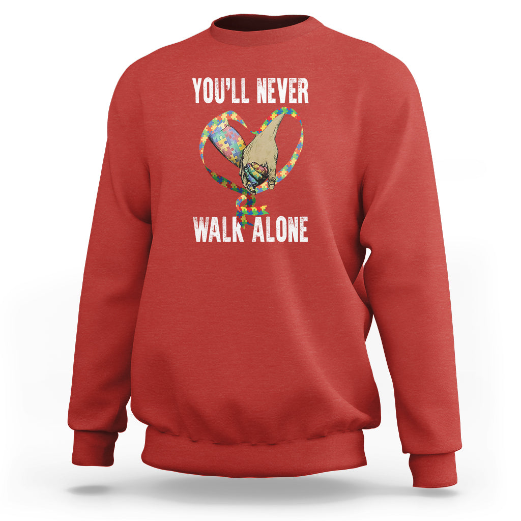 Red crewneck sweatshirt with 'YOU'LL NEVER WALK ALONE' cat-and-heart graphic on back.