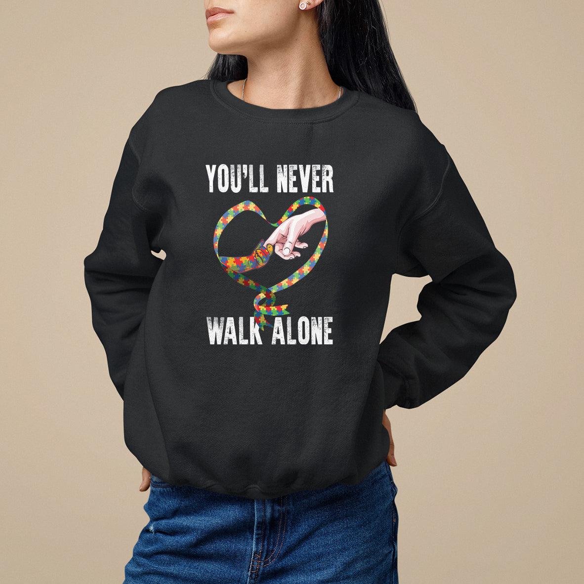 Black sweatshirt with heart graphic and "YOU'LL NEVER WALK ALONE" text.