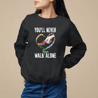 Black sweatshirt with heart graphic and "YOU'LL NEVER WALK ALONE" text.