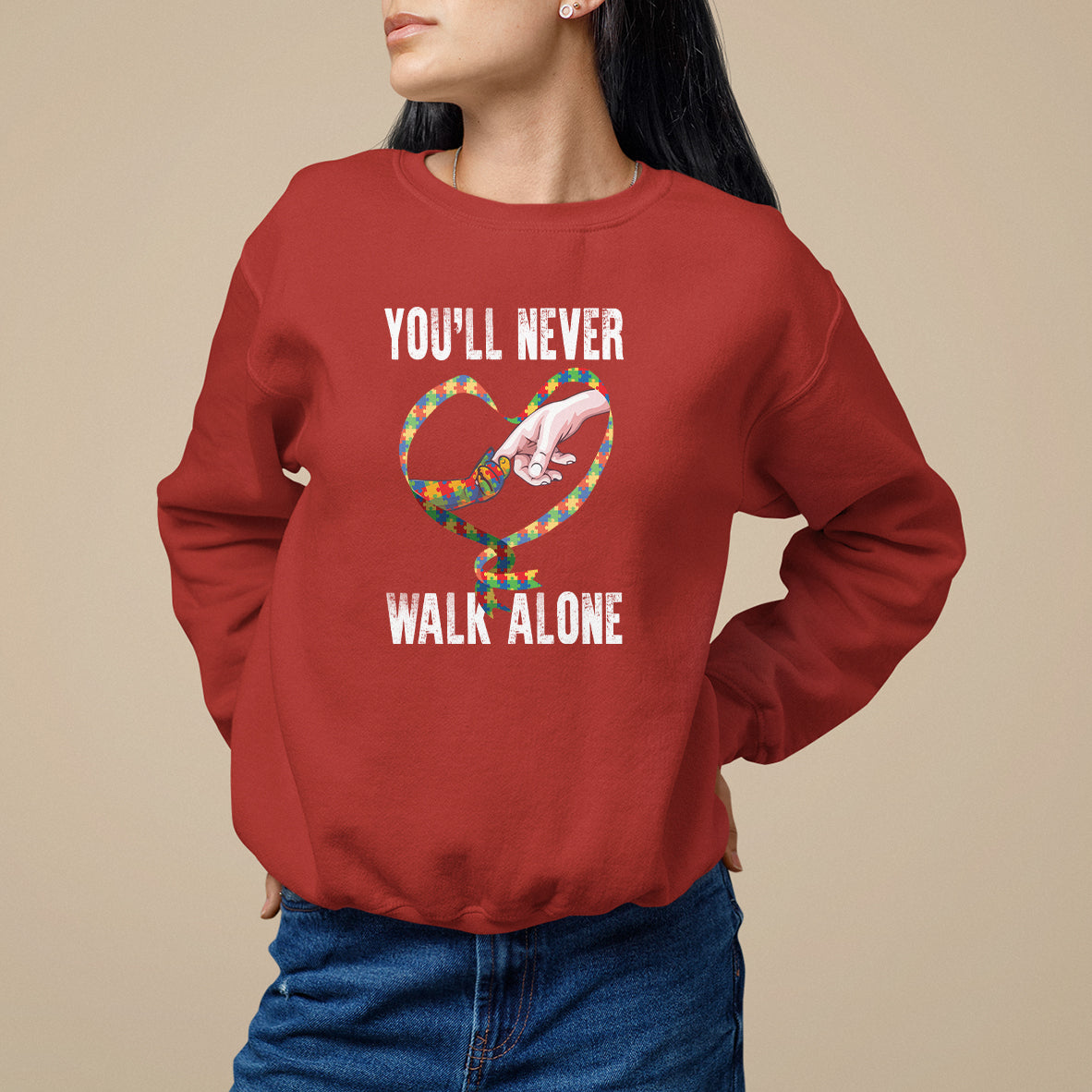 Red sweatshirt with heart graphic and "YOU'LL NEVER WALK ALONE" text.