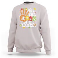 Ice gray autism awareness sweatshirt with colorful “See the able not the label” graphic.
