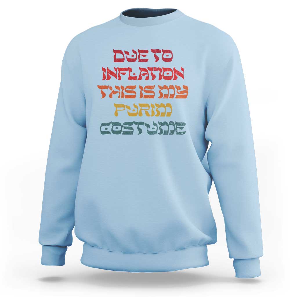 Light blue crewneck sweatshirt with colorful Hebrew-style text graphic on the chest