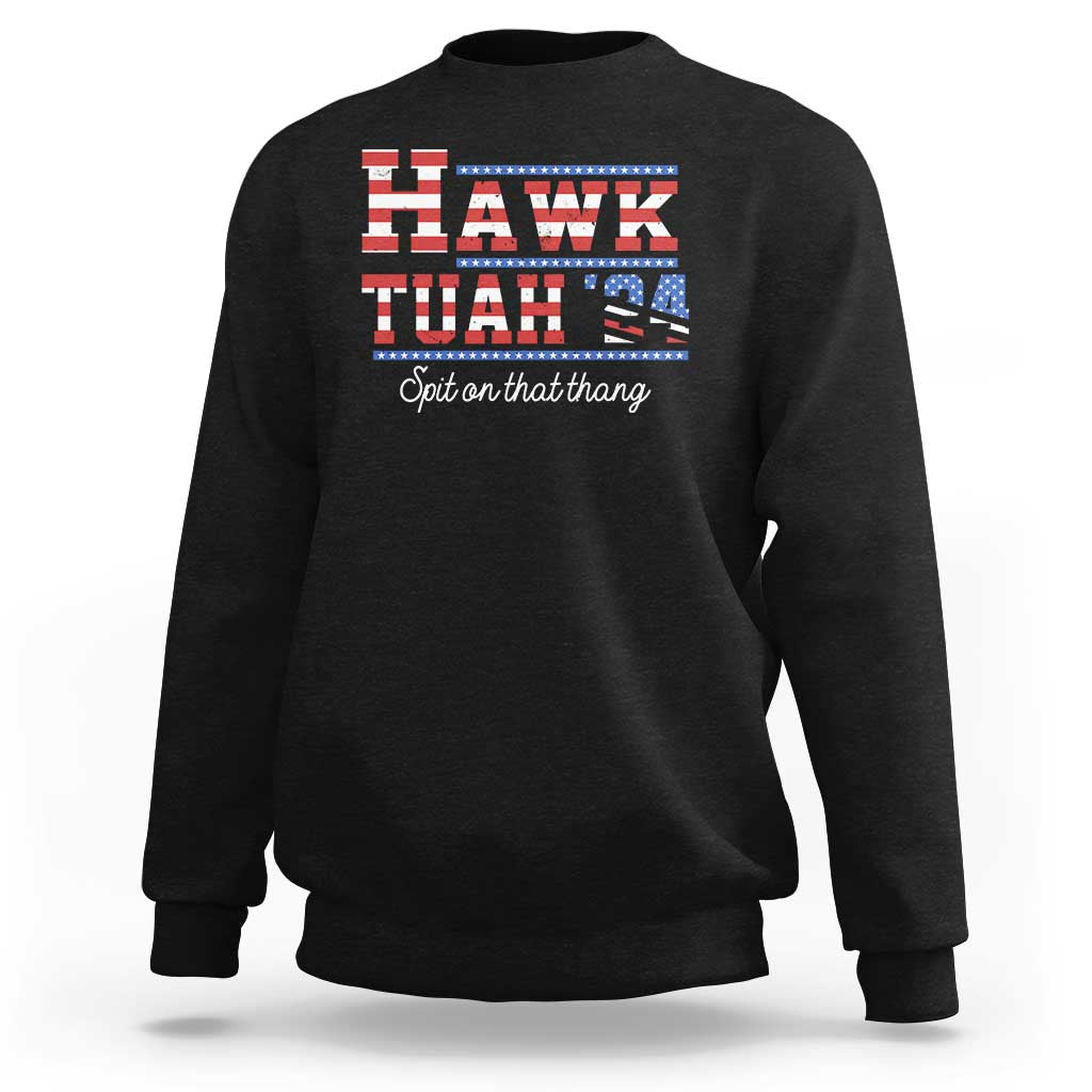 Black crewneck sweatshirt with “HAWK TUAH” graphic and “Spit on that thang” text