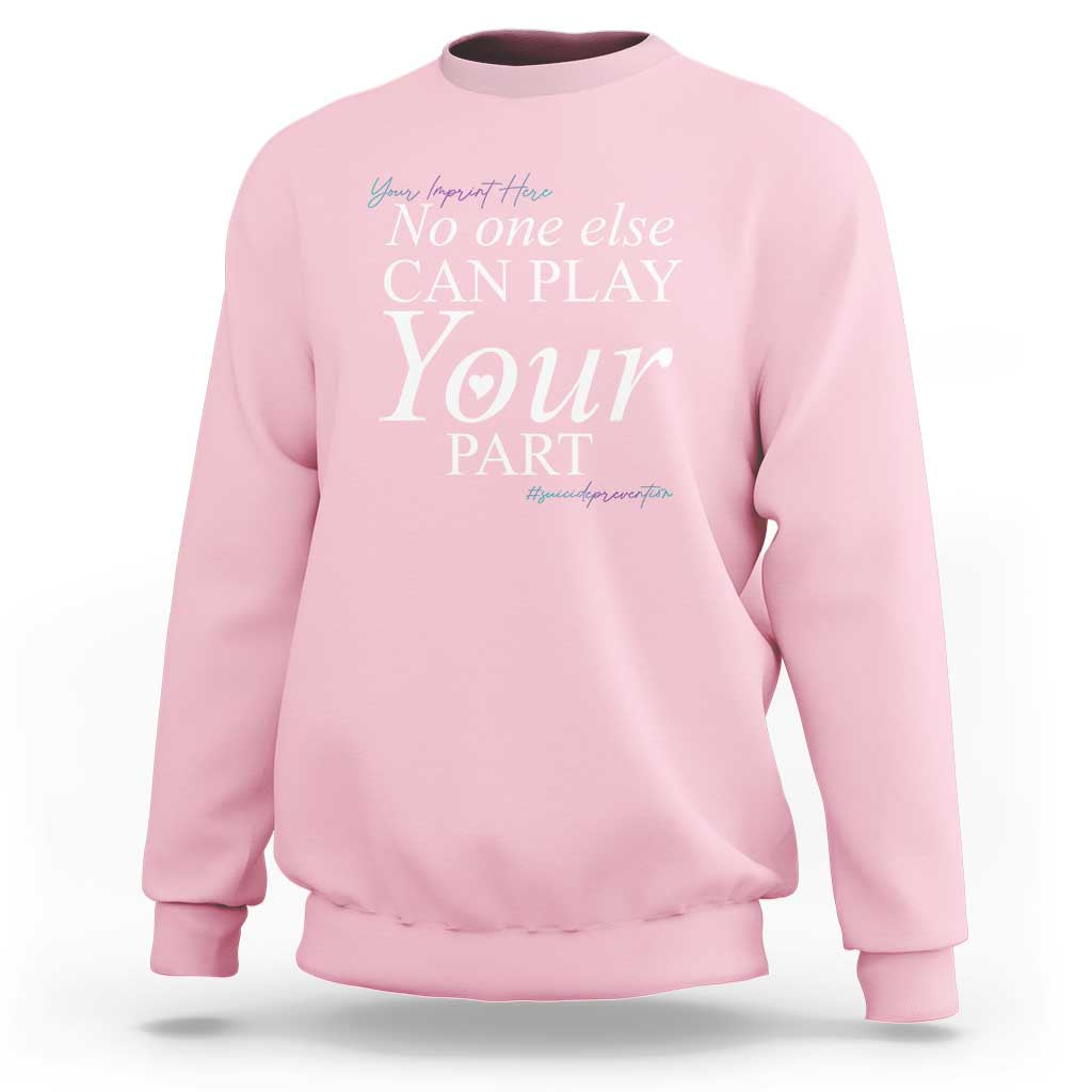 Light pink suicide prevention sweatshirt with “No one else CAN PLAY Your PART” graphic
