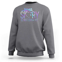 Charcoal gray suicide prevention sweatshirt with heart and “Your story is not over yet” print