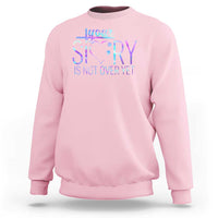 Light pink suicide prevention sweatshirt with heart and “Your story is not over yet” print