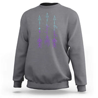 Gray crewneck sweatshirt with purple and teal arrow-and-script graphic on back