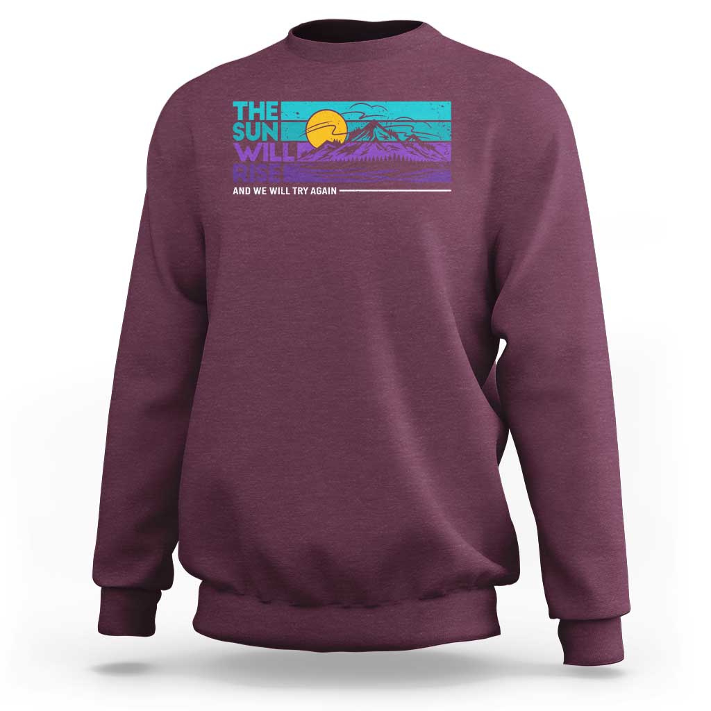 Crewneck sweatshirt in maroon with colorful sunrise and mountain graphic
