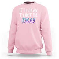 Light pink crewneck sweatshirt with “It is okay to not be okay” front graphic