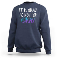 Navy crewneck sweatshirt with “It is okay to not be okay” front graphic