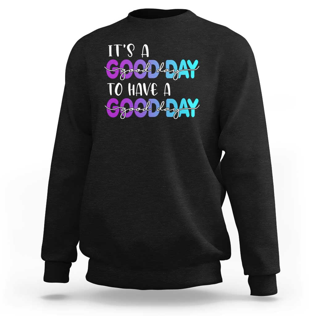 Black sweatshirt with front "It's a Good day" text graphic in white and pink/blue