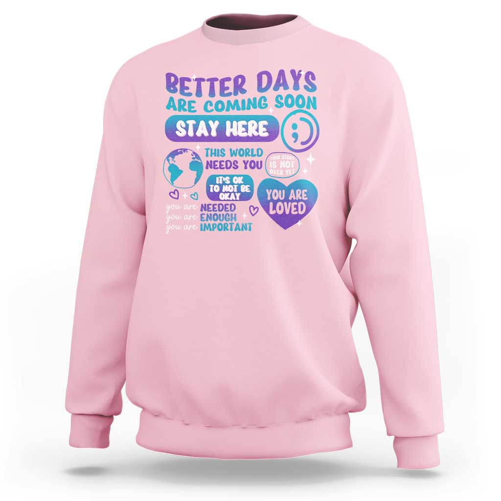 Light pink unisex sweatshirt with “Stay Here” suicide prevention message graphic on front