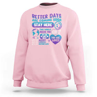 Light pink unisex sweatshirt with “Stay Here” suicide prevention message graphic on front