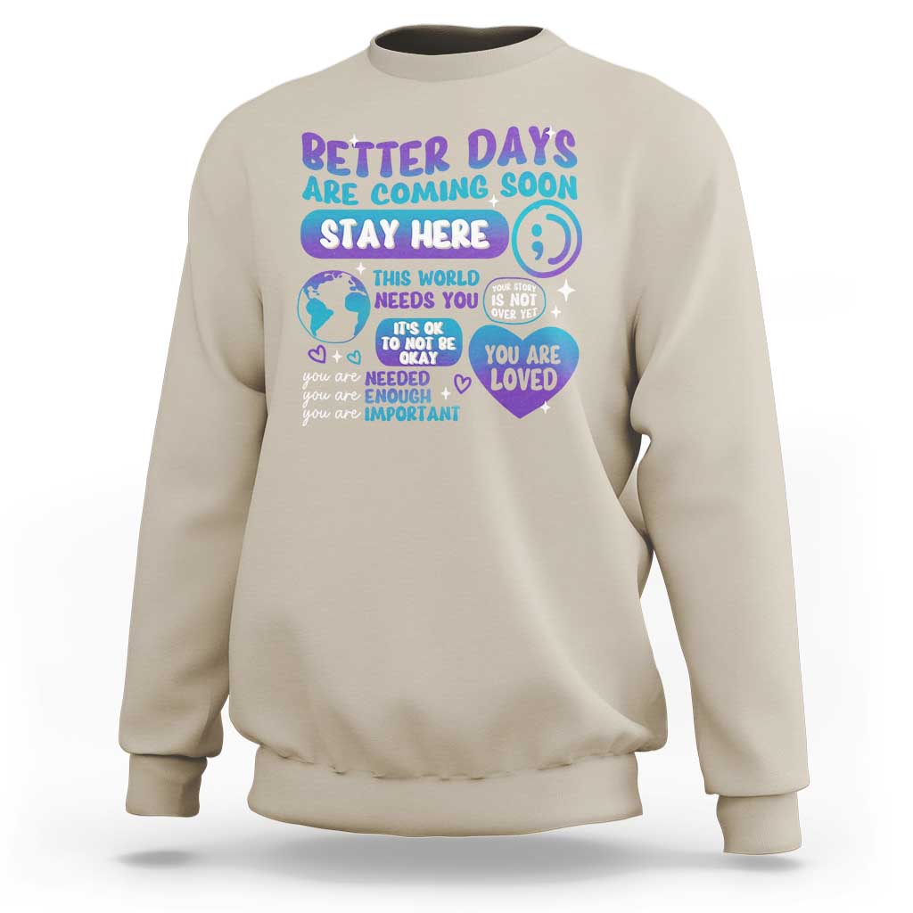 Sand unisex sweatshirt with “Stay Here” suicide prevention message graphic on front