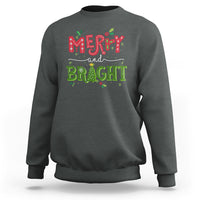 Dark heather crewneck sweatshirt with 'Merry and Bright' holiday graphic
