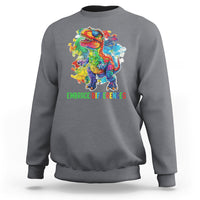 Charcoal gray crewneck sweatshirt with colorful dinosaur puzzle graphic and green slogan text.