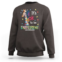 Dark chocolate autism awareness sweatshirt with colorful giraffe graphic and 'It's ok to be different'.