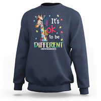 Navy autism awareness sweatshirt with colorful giraffe graphic and 'It's ok to be different'.