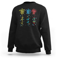 Black crewneck sweatshirt with colorful sea turtle autism awareness graphic on back