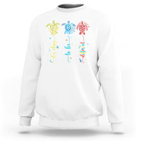 White crewneck sweatshirt with colorful sea turtle autism awareness graphic on back