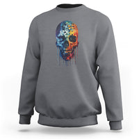 Charcoal gray crewneck sweatshirt with colorful puzzle skull graphic on the chest.