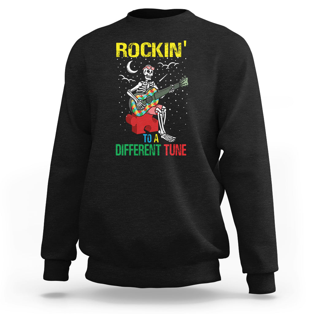 Black crewneck sweatshirt with skeleton guitarist graphic and “Different Tune” text