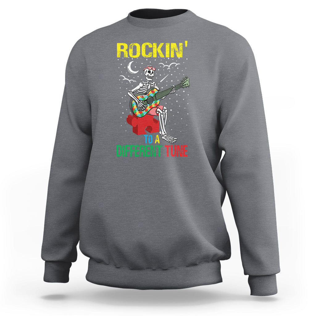 Charcoal gray crewneck sweatshirt with skeleton guitarist graphic and “Different Tune” text