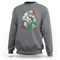 Charcoal gray crewneck sweatshirt with Bigfoot puzzle warrior graphic on chest