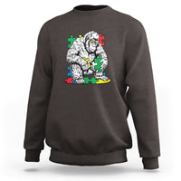 Dark chocolate brown crewneck sweatshirt with Bigfoot puzzle warrior graphic on chest
