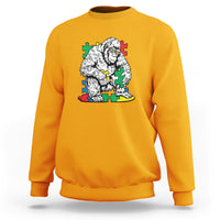 Gold yellow crewneck sweatshirt with Bigfoot puzzle warrior graphic on chest